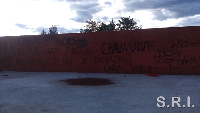 Graffiti left by Chava, "We want public works, not remodeling of façades," framed by other slogans painted after his murder.